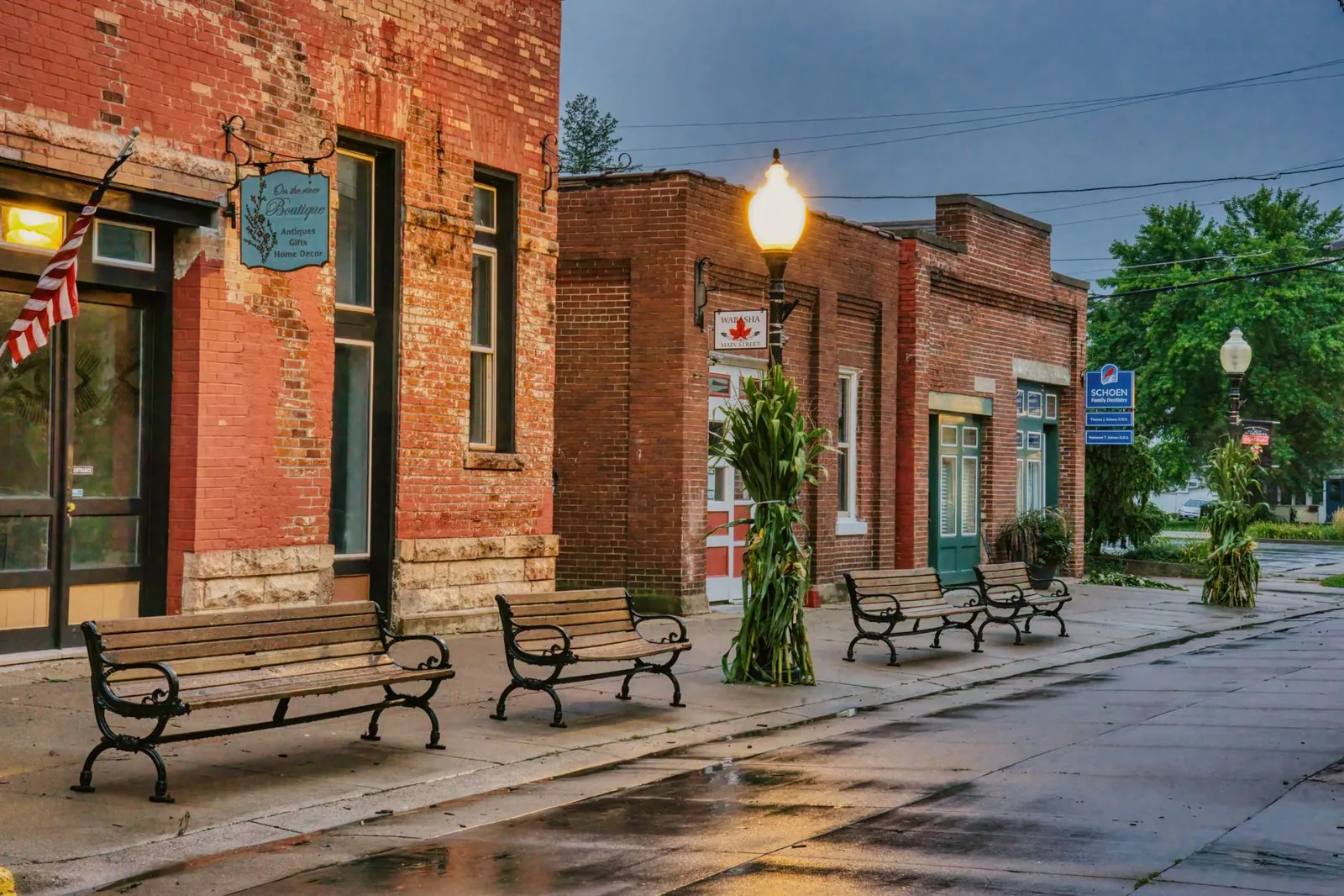 Old brick storefronts and benches on a small-town main street